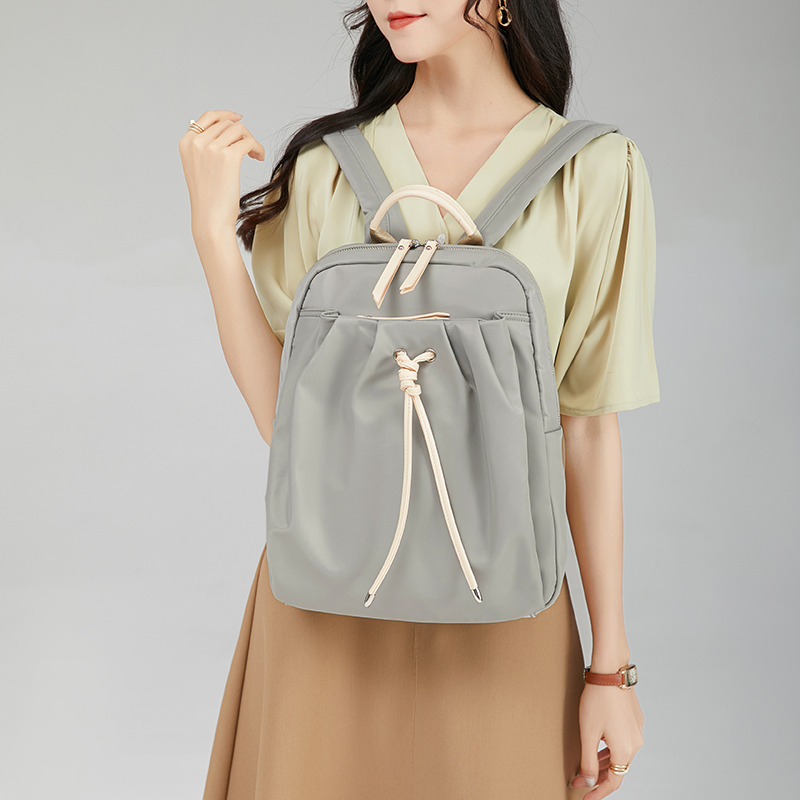12695398.《广州质造》佐木双肩包女新款牛津布抽绳休闲学生书包时尚大容量简约百搭背包